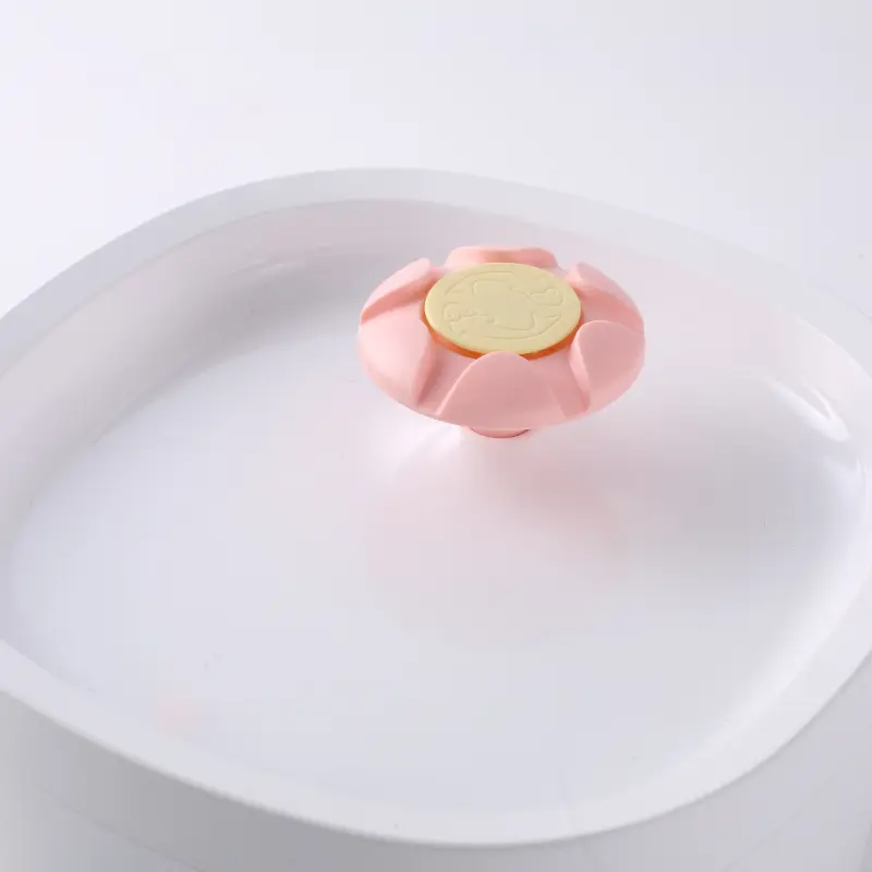 Pink flower-shaped pet water fountain spout with a yellow filter disc.