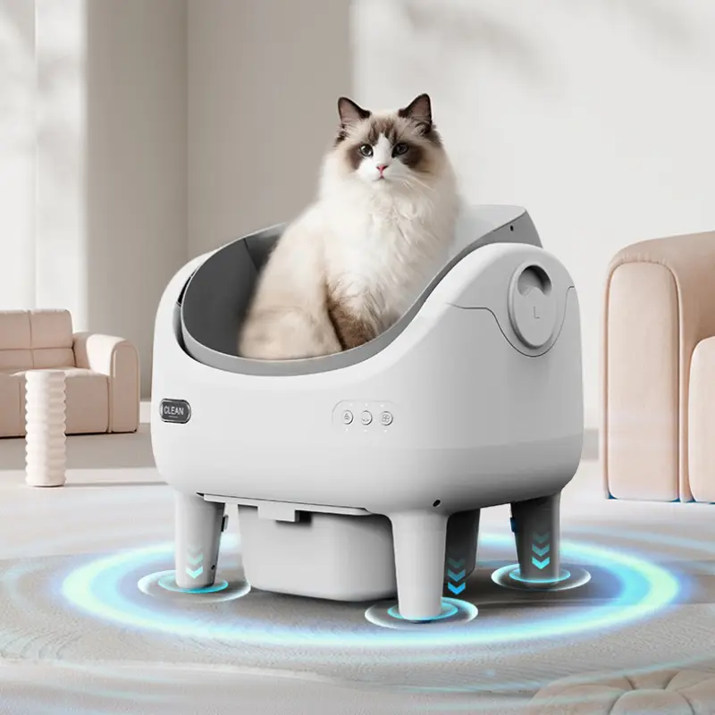 A Ragdoll cat rests inside a smart self-clean cat litter box with smart sensor rings in a bright modern pet home interior