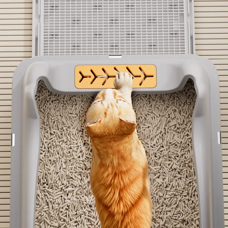 A ginger cat steps on the mesh of a stainless steel cat litter box, showing its easy-clean & hygienic design.