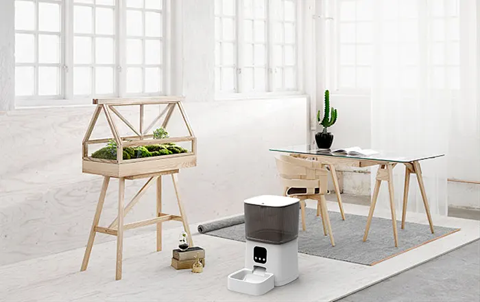 Smart Pet Feeder – Seamless Integration into Modern, Minimalist Home Design Sleek white smart pet feeder in a minimalist, bright modern home interior.