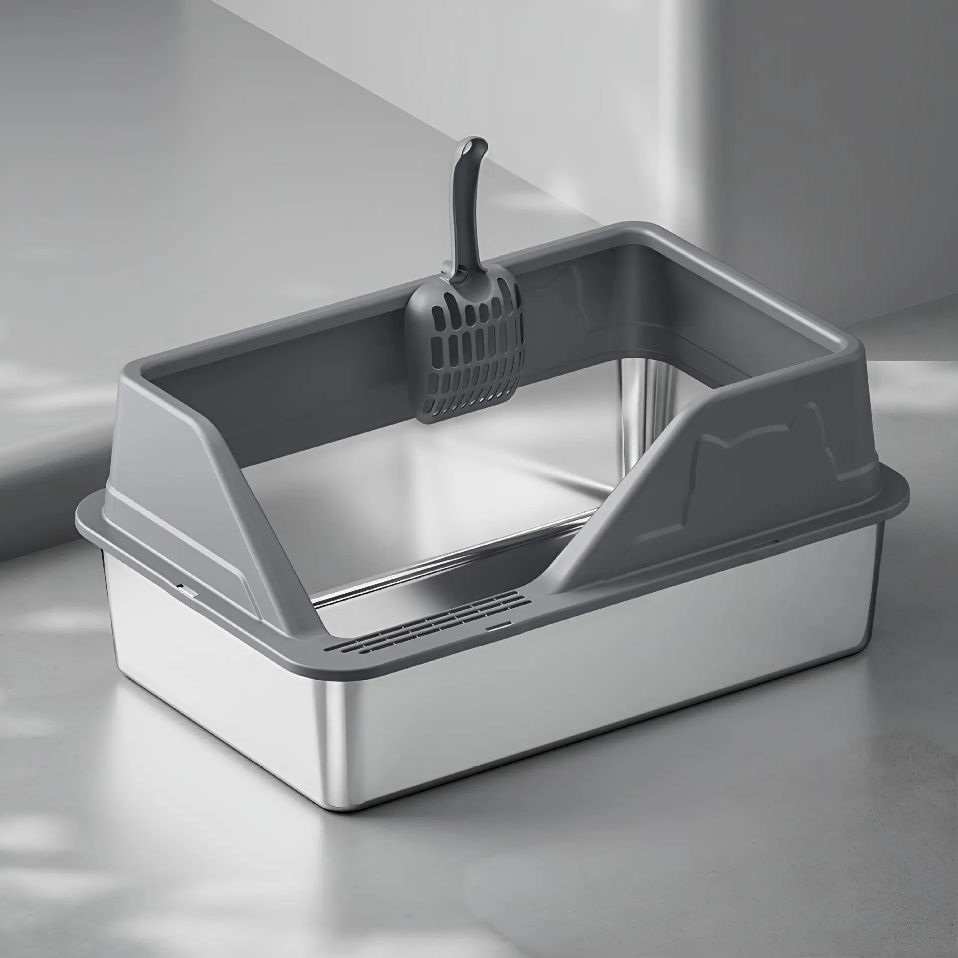 Modern gray-rimmed stainless steel cat litter box with attached scoop on a polished light gray surface