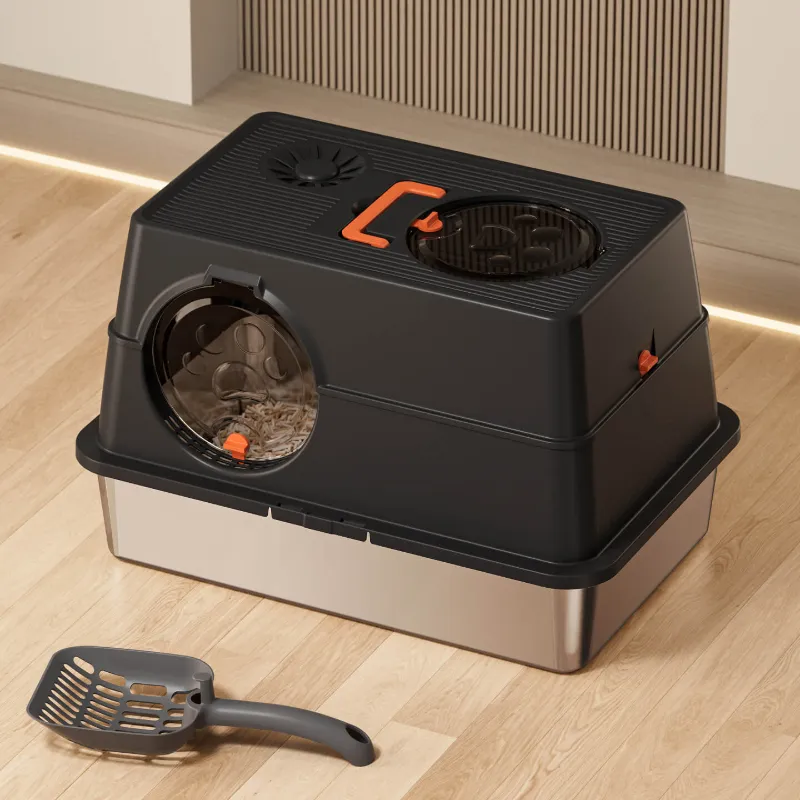 Stainless steel cat litter box with orange handle, matching litter scoop on wooden floor